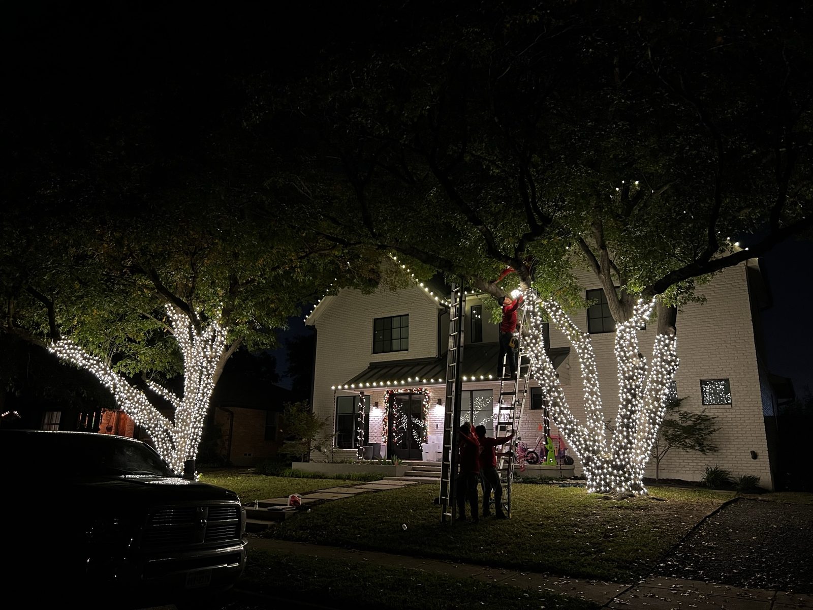 Christmas light installation McKinney TX brick home red and white C9
