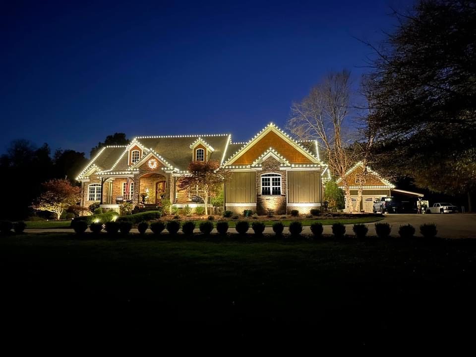 Christmas light installer truck and crew at luxury home in Plano TX