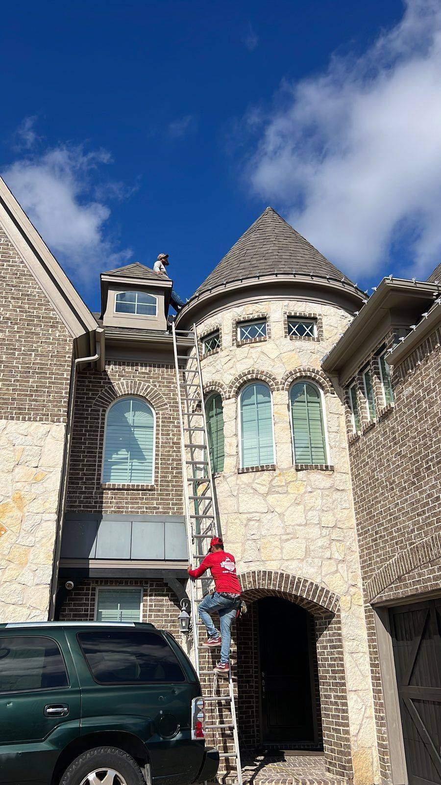 Christmas light installer crew on Frisco TX stone castle home Christmas light installer crew on Frisco TX stone castle home