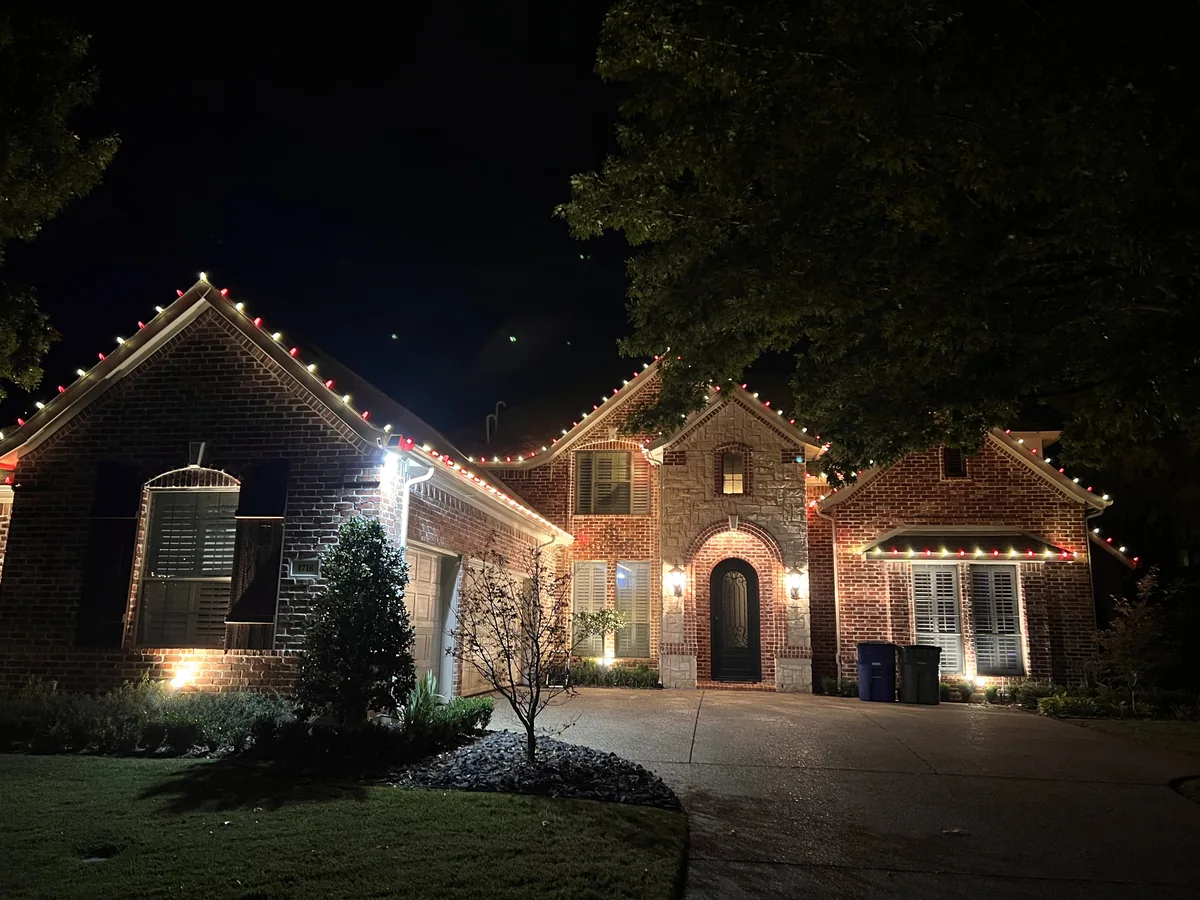 Christmas light installation Allen TX — warm white roofline on a brick home