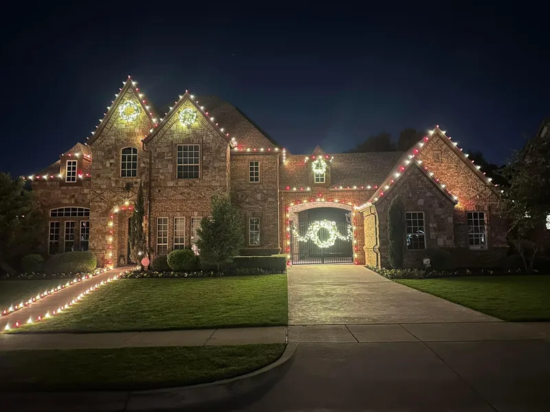 Christmas light installation Allen TX — warm white roofline, wreaths and path lighting on a brick home