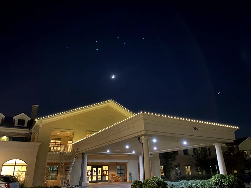 Commercial Christmas light installation DFW — warm white roofline on a corporate property at night
