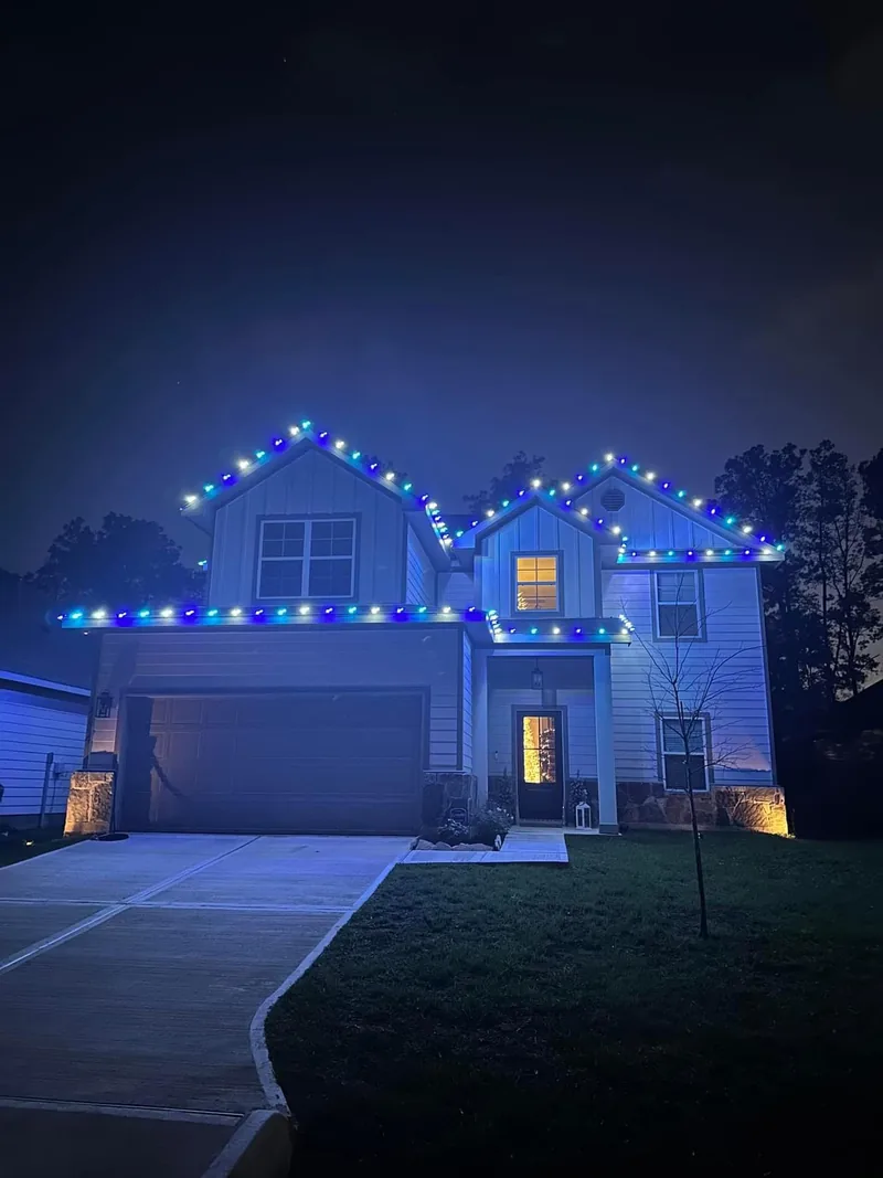 Christmas light installation Frisco TX — multicolor roofline lighting on a two-story home